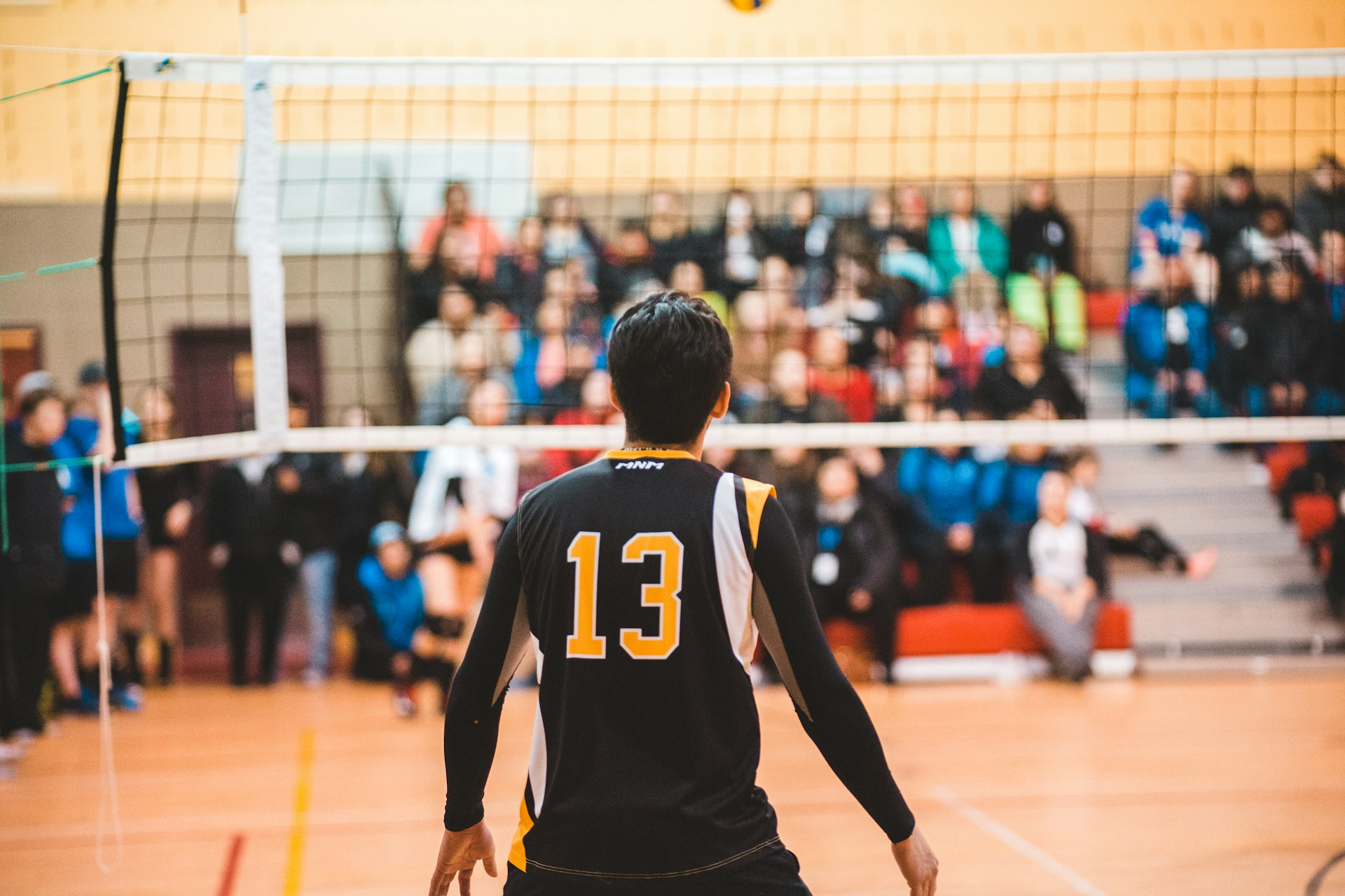 Volleyball Match at Netaji Indoor man wearing black 13 volleyball jersey