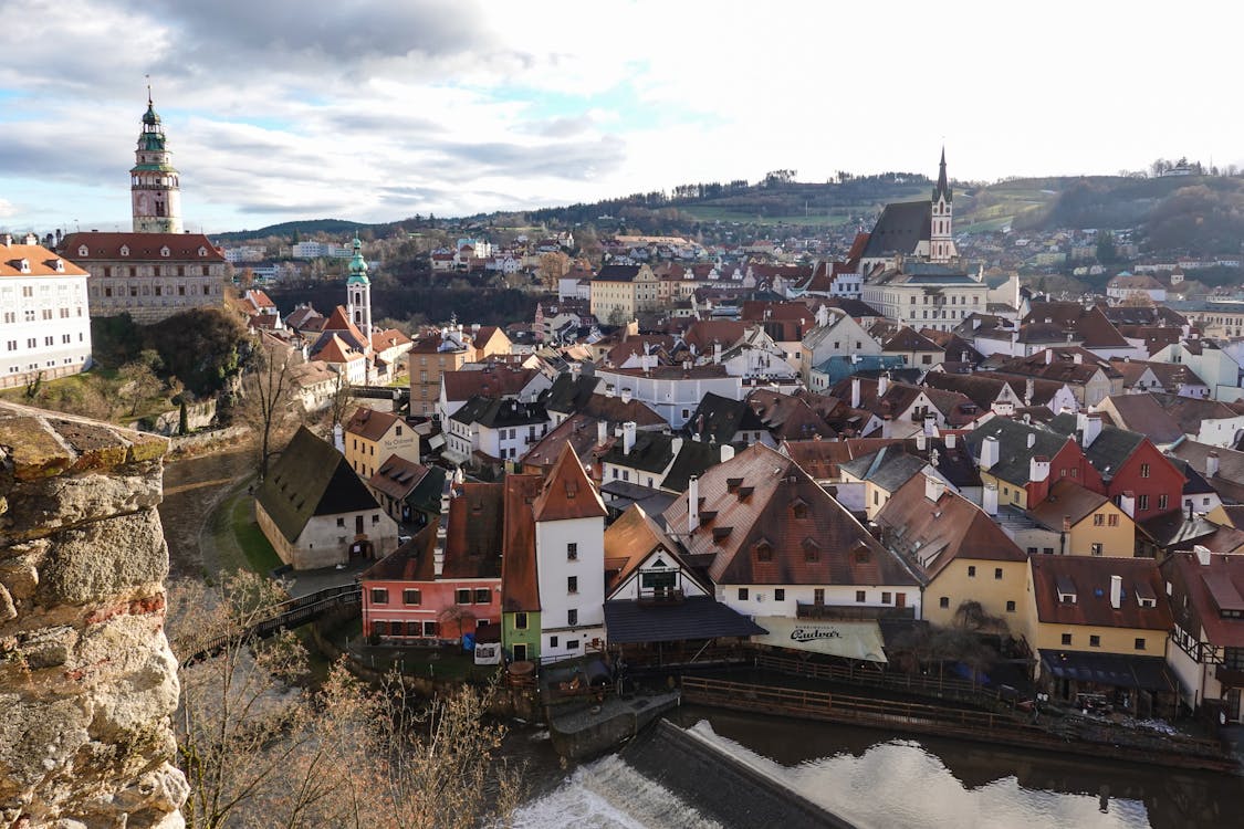 A panoramic shot of Český Krumlov from the castle tower, showing the winding Vltava River and red rooftops.