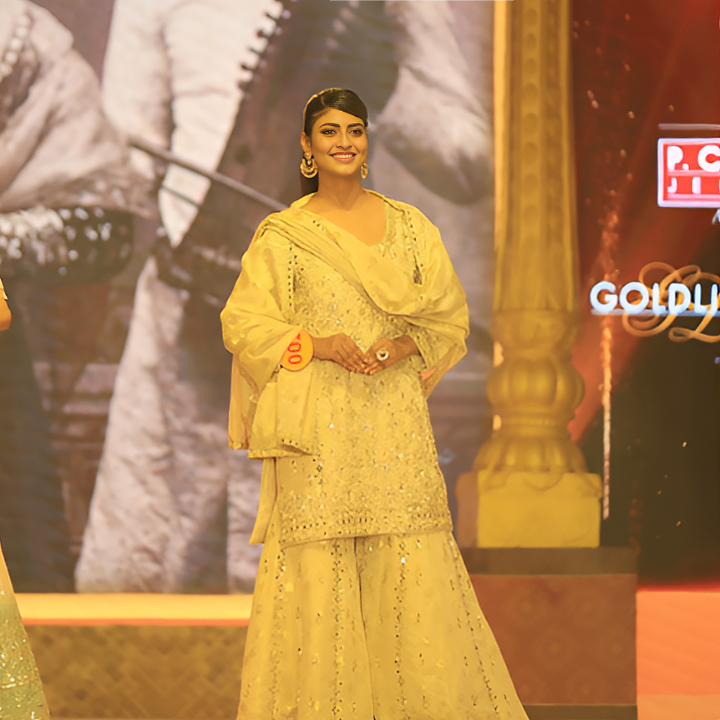 Aiswariya Sinha on stage in an elegant traditional outfit, marking a pivotal moment in her modelling journey.