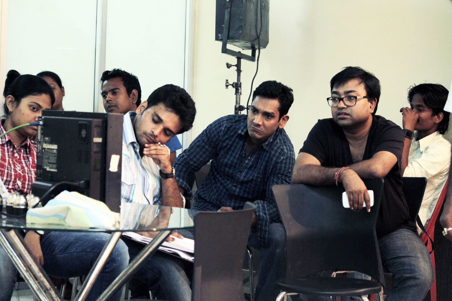 Drono Acharya in a studio with his team, directing dubbing work—building eastern India’s leading production house.