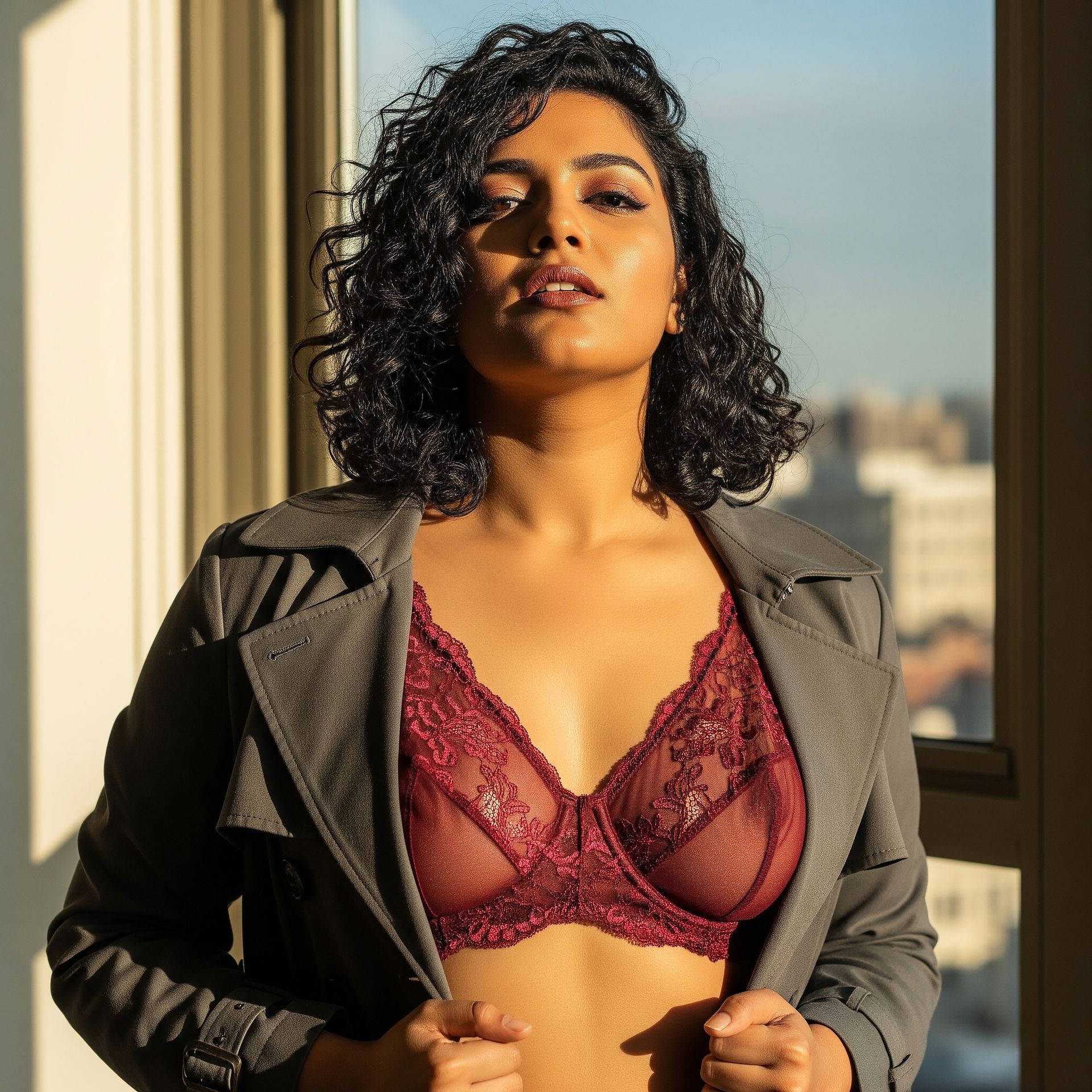 Confident woman wearing a sheer bralette styled with outerwear, looking empowered and self-assured, symbolizing the bold, body-positive message of 2025 lingerie fashion.