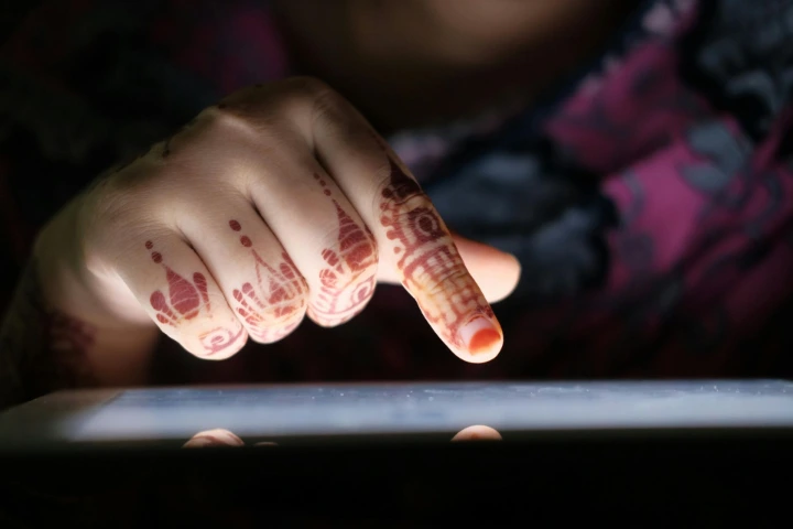 Close-up of a bride’s fingertip mehndi design with minimalist motifs and clean hand