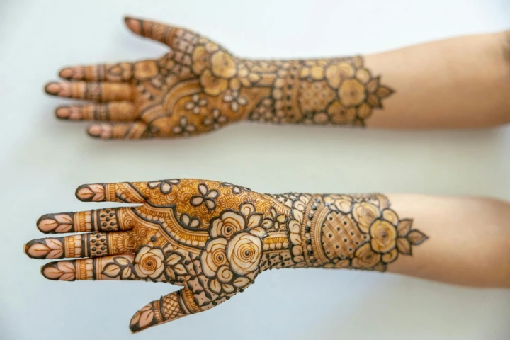Floral mehndi design wrapped around the wrist, mimicking a delicate bracelet-style pattern.