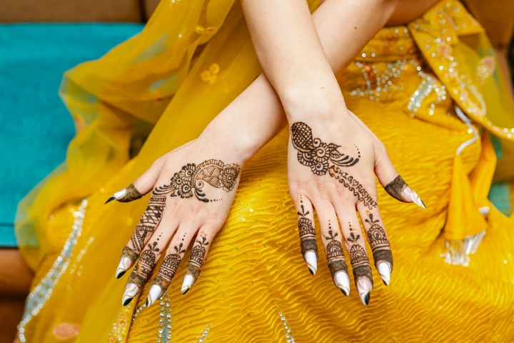 Chic half-hand mehndi design on bride’s hands with elegant detailing